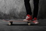 Legs in sneakers on a skateboard