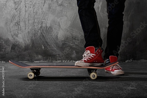 Fototapeta dla dzieci Legs in sneakers on a skateboard