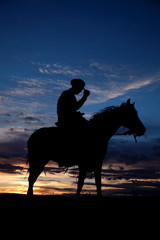 Wall Mural - Cowboy holding hat horse sunset
