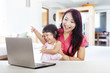 © Creativa Images - Cheerful family with laptop computer