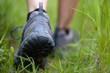 © redzigzag.com - Closeup of hiking boots in a grass