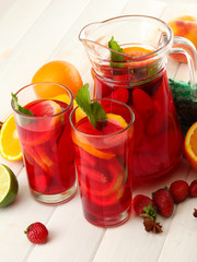 Poster - sangria in jar and glasses with fruits, on white wooden table