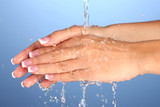 Fototapeta Łazienka - Washing woman's hands on blue background close-up