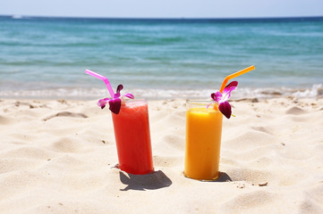 Wall Mural - Pair of fruit shakes on the tropical beach