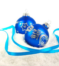 Christmas Blue Baubles And Ribbon On Snow