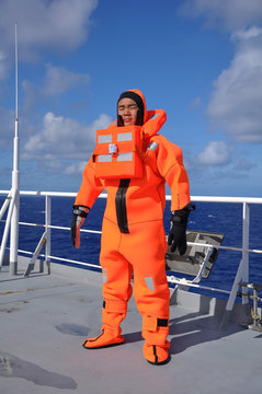 Fototapete - seaman in immersion suit and life jacket