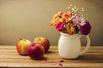 Wall Mural - Beautiful flower bouquet and fresh apples on wooden tabletop