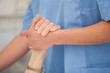 © WavebreakMediaMicro - Nurse holding hands of the elderly lady