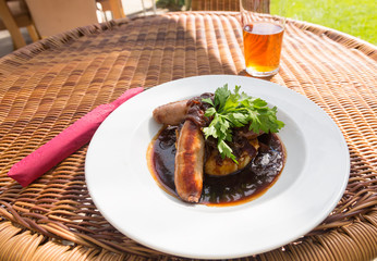 Sausage and mash with gravy in english pub