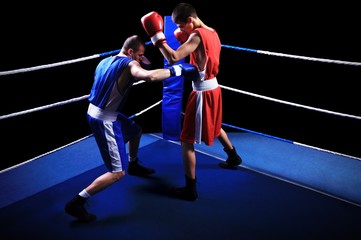 Two male boxers fighting in ring