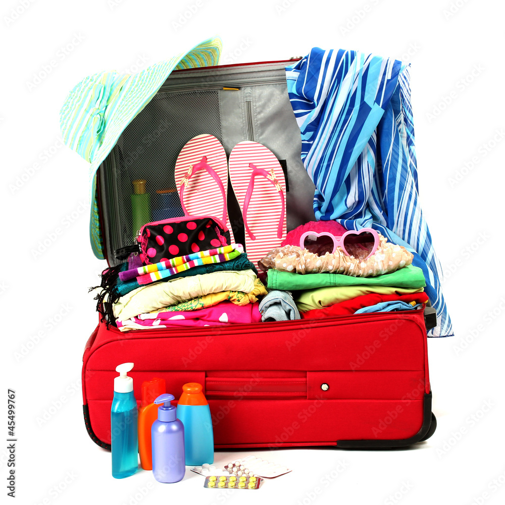 Red travel suitcase with personal belongings isolated on white