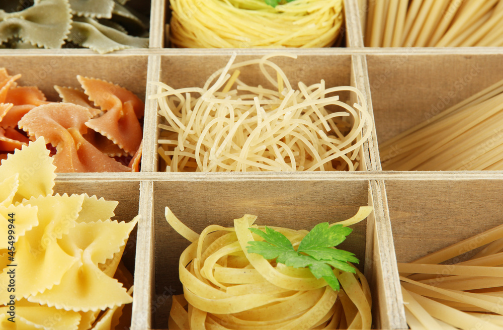 Nine types of pasta in wooden box sections close-up