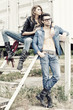 © matusciac - stylish couple wearing jeans and boots posing dramatic