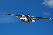 Seaplane Catalina In Flight On Blue Sky
