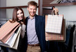 © Karramba Production - Cheerful couple show their purchases after shopping