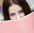 © Karramba Production - Female student reads the book at the library