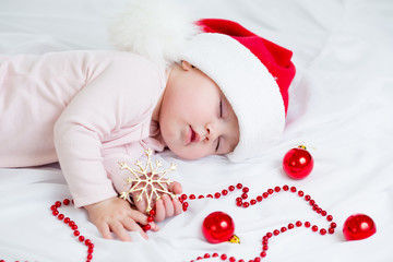 Fototapete - sleeping baby girl Santa Claus