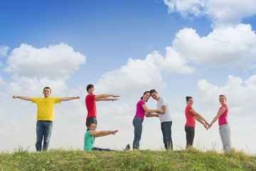 Group of people spelling word TEAM outdoors in nature