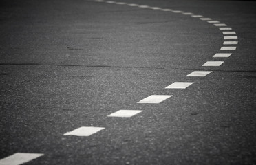 Wall Mural - Turning asphalt road with marking lines. Close up photo