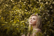 © VectorART - beautiful blonde among the flowers in the park