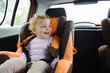 © spass - Happy child smiling in car seat