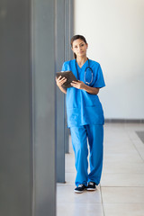 Wall Mural - young female healthcare worker using tablet computer in hospital