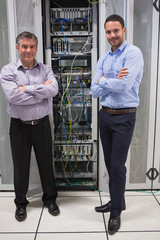 Poster - Two technicians standing in front of servers