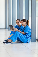 Wall Mural - female nurses using tablet computer during break