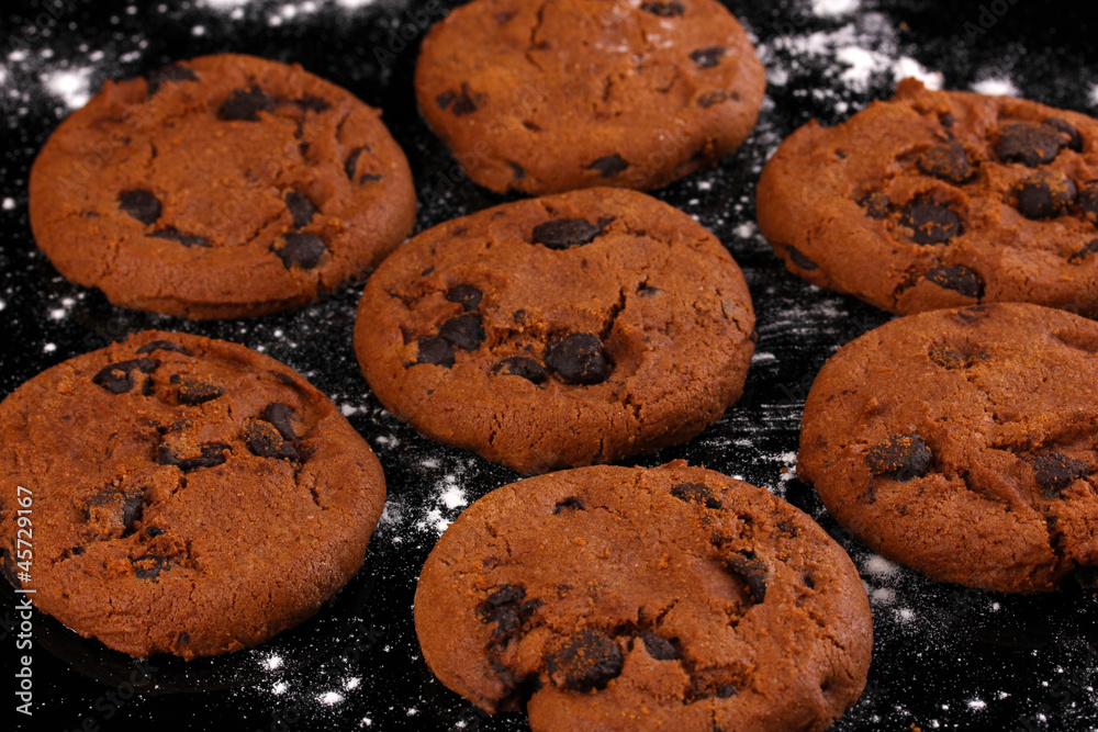Chocolate chips cookies isolated on black