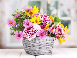 Sticker - beautiful bouquet of bright flowers in basket on wooden table