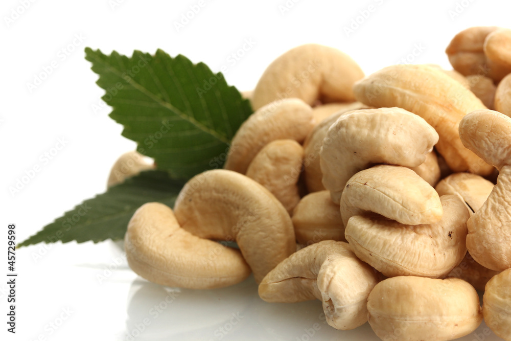 tasty cashew nuts with leaves, isolated on white