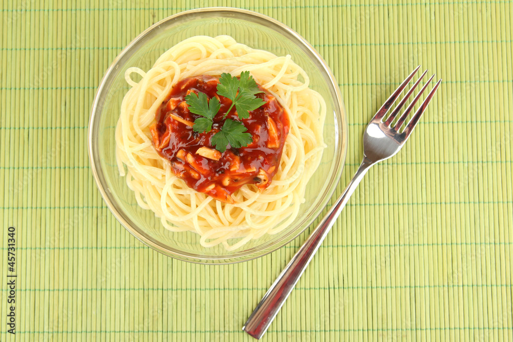 Italian spaghetti in plate on bamboo mat