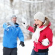 Winter fun - couple in snowball fight
