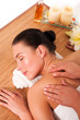 Relaxed beautiful young woman having a spa massage on her back