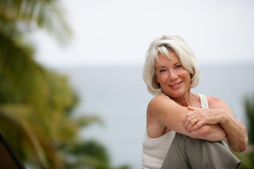 Elderly woman enjoying a day out by the lake