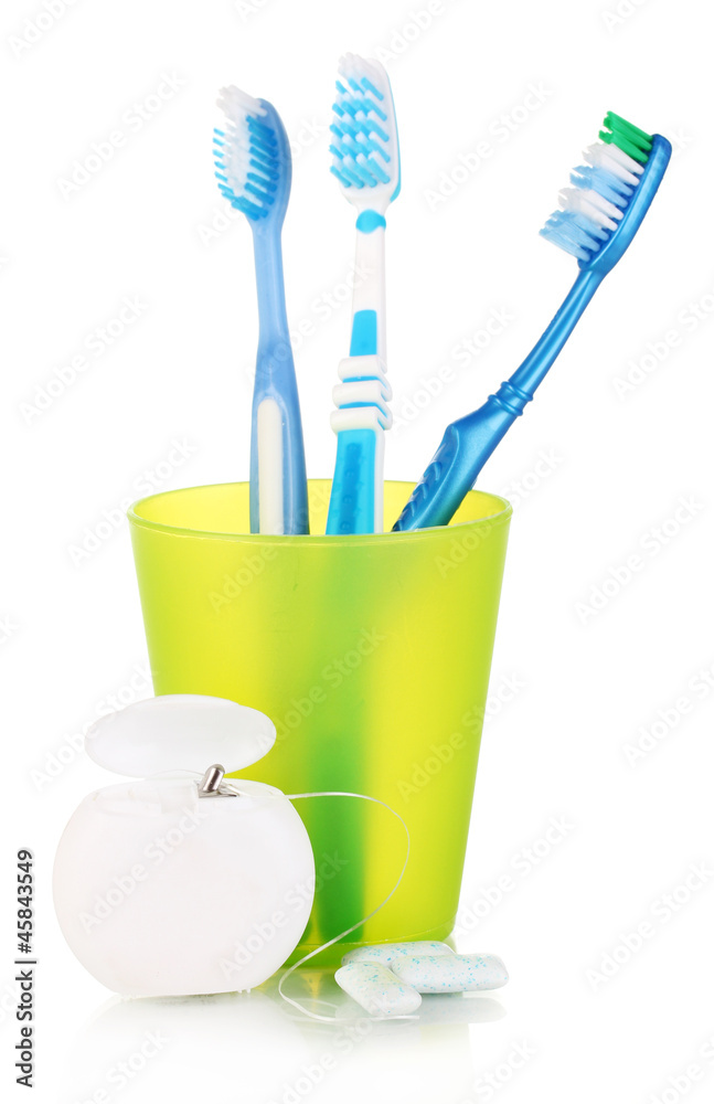 Toothbrushes, chewing gum and dental floss isolated on white