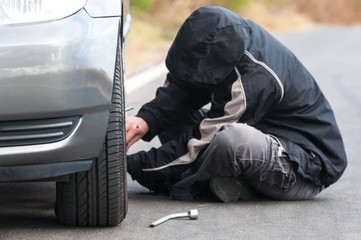 Poster - Young man repairing car outdoors