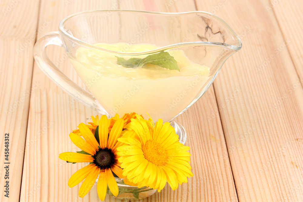 Mayonnaise in bowl on wooden table