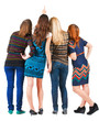 © ghoststone - Back view of group beautiful women pointing at wall.