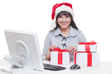 woman in santa hat making christmas gifts