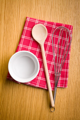 Wall Mural - Wire whisk, wooden spoon and ceramic bowl.