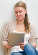 © M-Production - Young woman using tablet computer