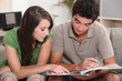 © auremar - Couple looking at a file at home