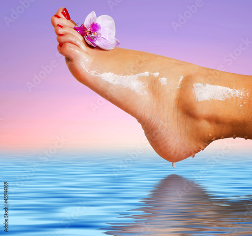 Fototapeta na wymiar wet foot with flower of orchid