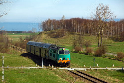 Naklejka ścienna Passenger train passing through countryside