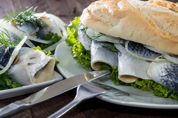 Canvas Print - Herring Filet on a baguette (against wood)