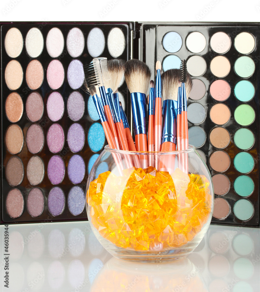 Make-up brushes in a bowl with stones