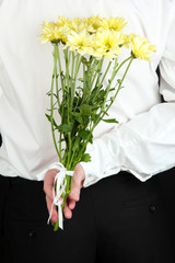 Wall Mural - man holding flowers close-up