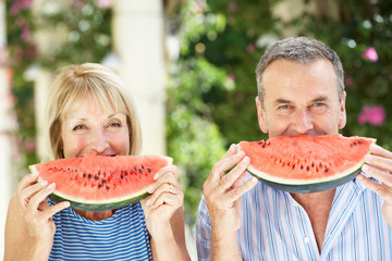 Wall Mural - Senior Couple Enjoying Slices Of Water Melon