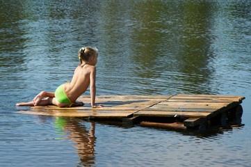 little girl sits on a raft